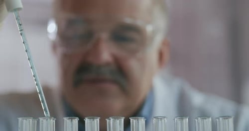 Close Up of Lab Tech with Pipette and Tubes