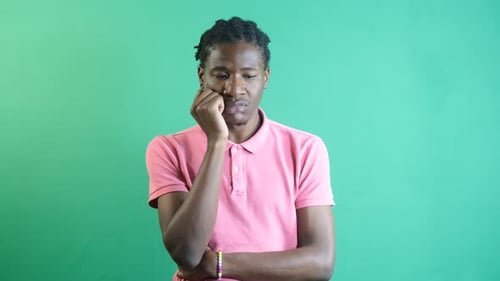 Young Adult Thinking Against Green Screen