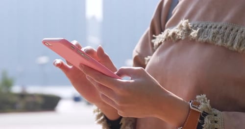 Close Up of Adult Using Phone in Urban Setting