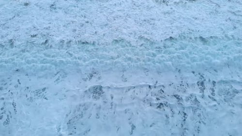 Huge white foamy sea waves, top view