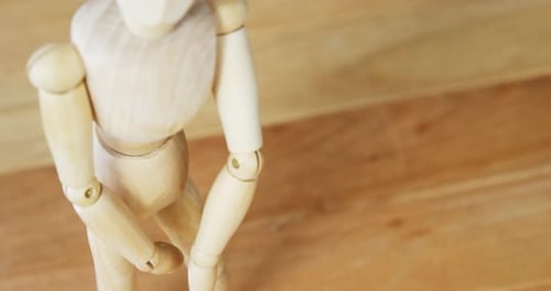 Wooden Mannequin Standing on Wooden Surface