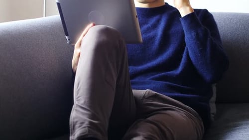 Young Adult Using Tablet and Mobile Phone