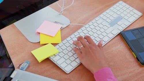 Person Typing and Using Graphics Tablet at Desk
