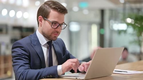 Successful Man Working on Laptop and Giving Thumbs Up