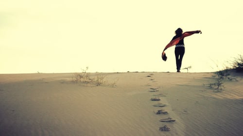 Woman in Desert with Flowing Orange Scarf