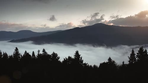 Mountains and Fog Flowing at Sunrise or Sunset