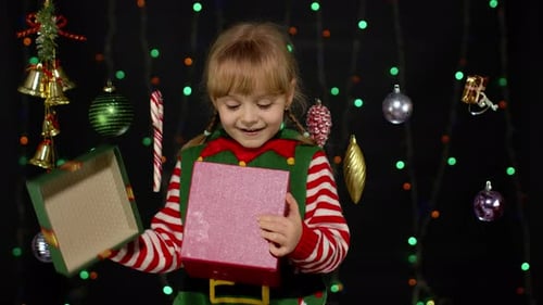 Girl Opens Christmas Gift in Festive Setting