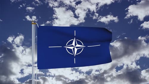Waving NATO Flag Against Dynamic Blue Sky with White Clouds