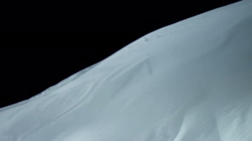 Flowing White Fabric Ripples Against Black Background
