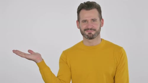 Portrait of Middle Aged Man Holding Product on Hand Advertising Gesture