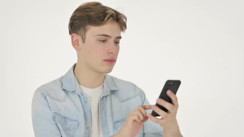 Young Man Celebrates Good News on Smartphone