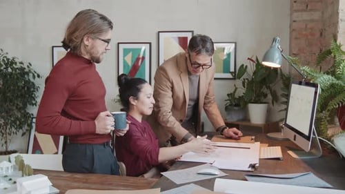 Architects Collaborating on a Project in a Modern Office