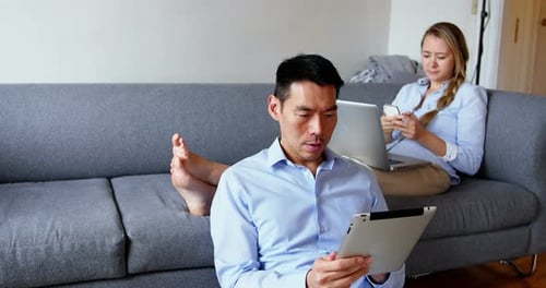 Man and Woman Working on Computers at Home