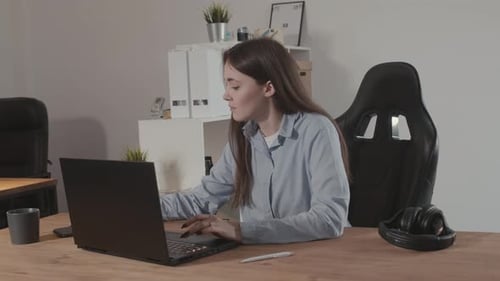 The Girl in the Office is Distracted By the Phone