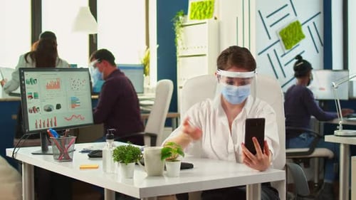 Woman Wearing Mask Having Video Call at Office