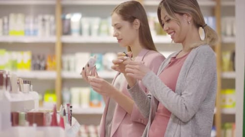 Happy Female Customers Choosing Makeup Products