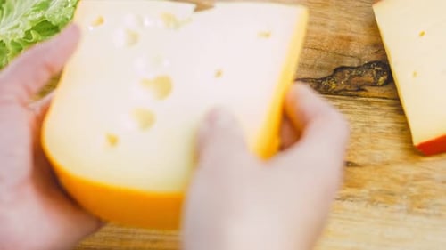 Close Up of Cheese Wedge being Held in Hands