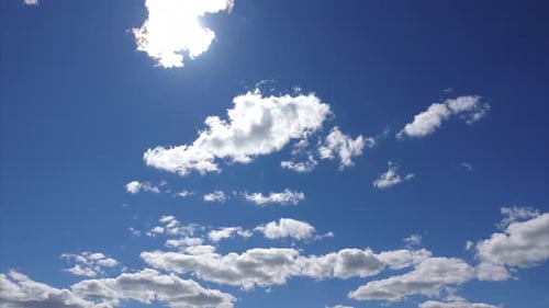 Clouds Float in a Bright Blue Sky