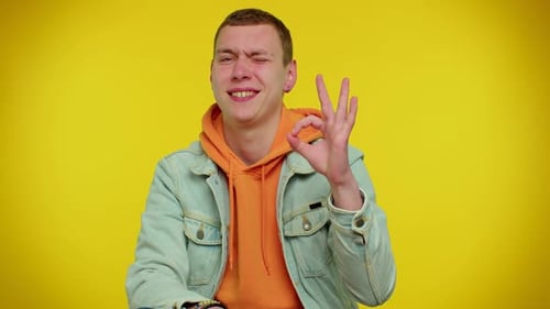 Young Adult Gives an OK Hand Gesture