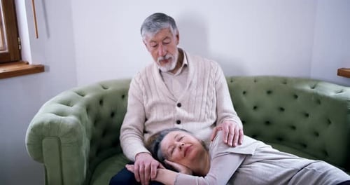 Affectionate Senior Couple Relaxing Together on Couch