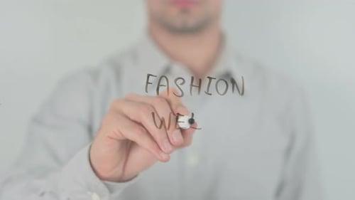 Man Writes Fashion Week on Clear Surface