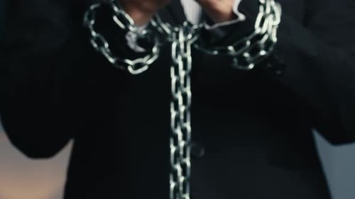 Man Dressed in Jacket with Chained Hands