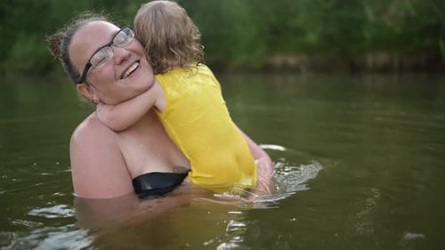 Woman and Child Enjoying Time in Lake
