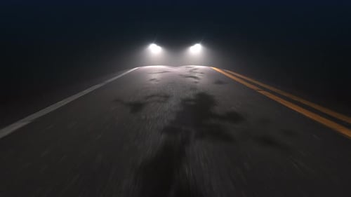 Car with Headlights on Follows Camera Tracking along Country Night Road