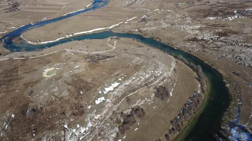 Curvy River Flowing Through Mountains Rocks
