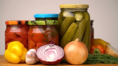Footage Glass Jars with Salted Vegetables for the Winter Rotated on Table