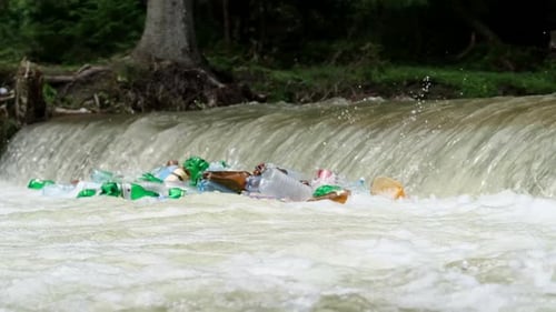 Plastic Garbage is Carried By the River Into the Ocean Plastic Bottles in the Water