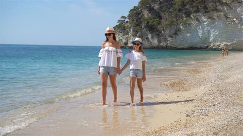 Beautiful Mother and Daughter at Caribbean Beach Enjoying Summer Vacation.