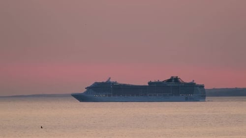 Cruise Ship Sail in Sea on Sunset with Sun