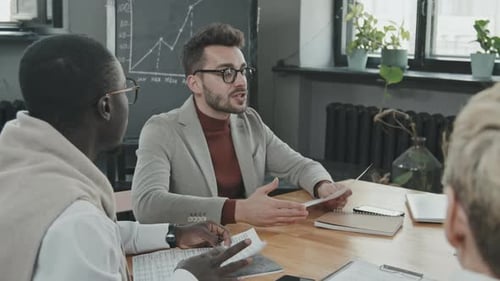 Corporate Team Discusses Strategy at a Meeting
