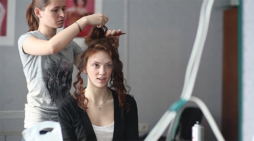 Young Woman Getting Hair Styled in Salon