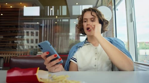 Young Pretty Woman Use Phone in Fast Food Diner
