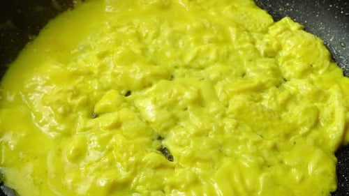 Close Up Scrambled Eggs Cooking In Pan