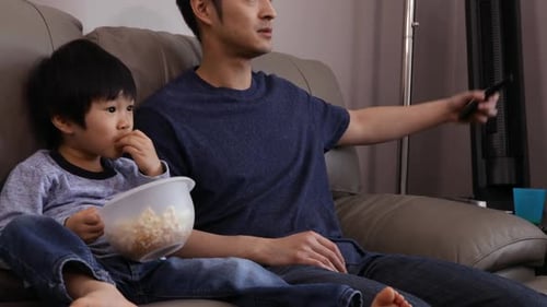 Father and Son Watch Television Together