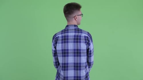 Rear View of Young Hipster Man Thinking and Looking Around
