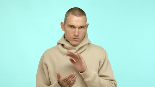 Slow Motion of Cool Tattooed Guy with Piercing Looking Serious and Applause Clap Hands and Stare at