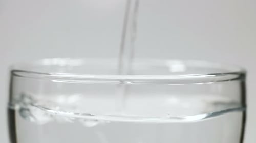 Refreshing Water Poured into Glass