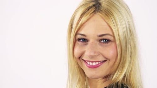A Young Attractive Woman Turns To the Camera and Smiles - Face Closeup - White Screen Studio