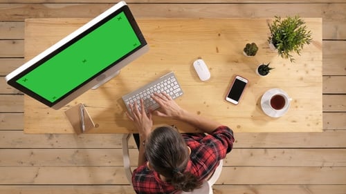 Young casual woman working on computer. Green Screen Mock-up