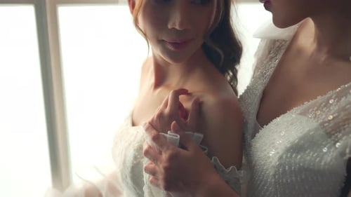 Brides Holding Each Other Tenderly on Wedding Day