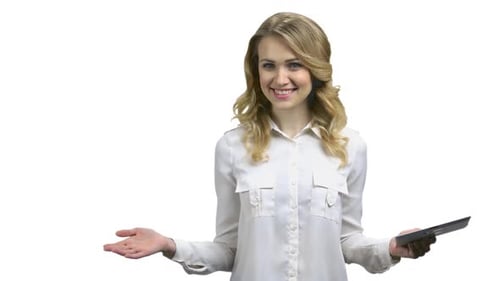 Woman Uses Tablet and Smiles on White Background
