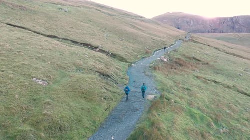 Aerial view of people hiking and climbing Snowdon mount in Wales on a sunny d