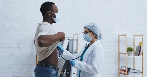 Doctor Listens to Patient's Breathing with Stethoscope