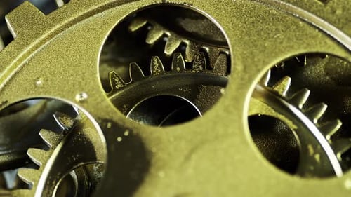 Rotating Gold Gears Interlocking in Detailed Macro Shot