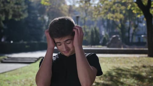 Young Man Smiling and Looking at Camera. Portrait of a Happy Handsome Young Man in a Urban Street