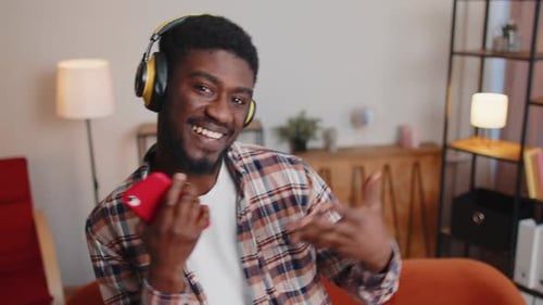 Young Man Listens to Music and Dances